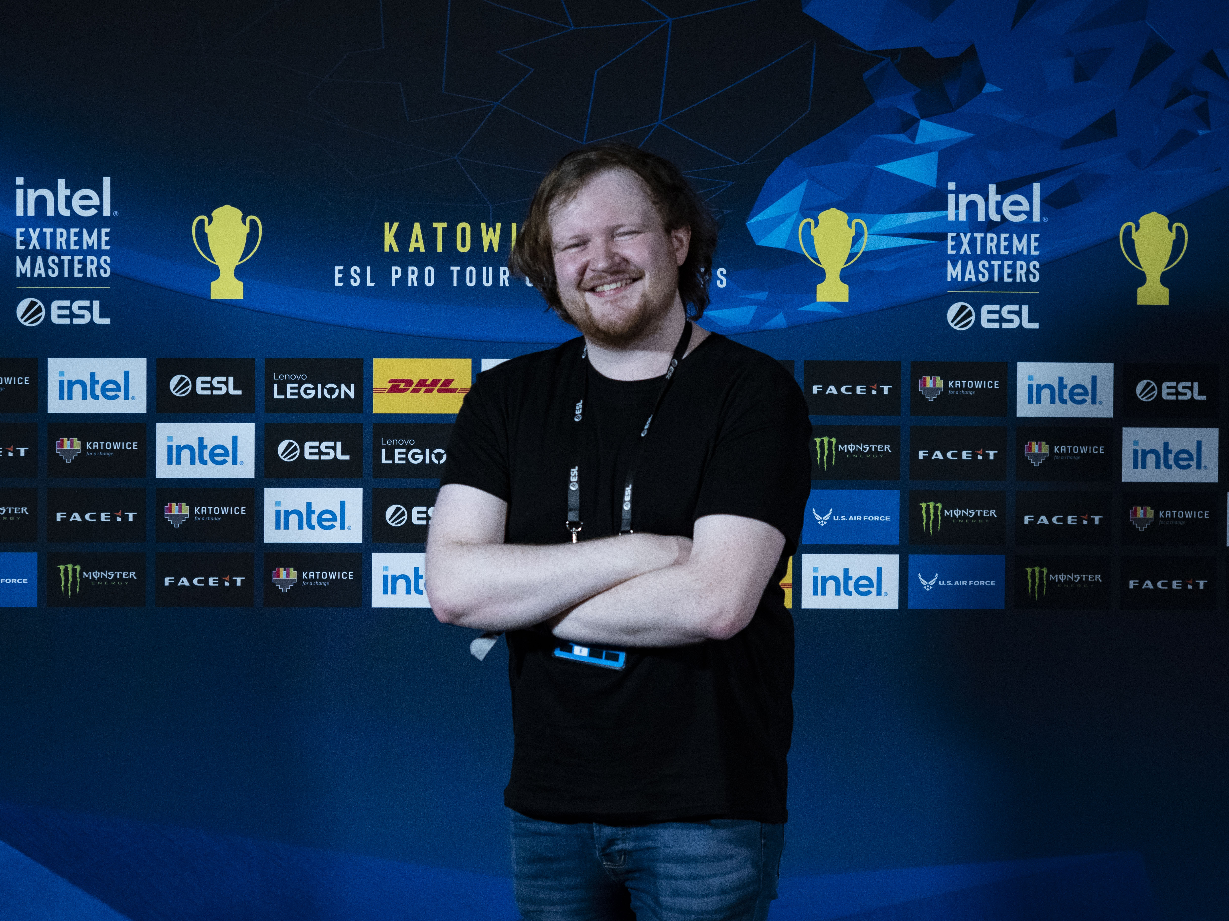 Adam Conway standing cross-armed in front of an ESL Katowice banner